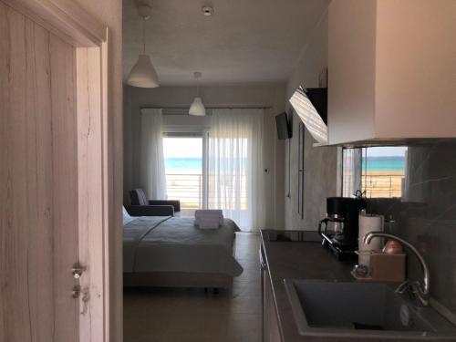 a bedroom with a bed and a view of the ocean at Alkyon Apartments Studios in Platanitis