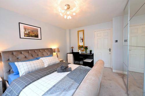 a bedroom with a large bed and a desk at 3 Bedroom House in Euston, Patio & BBQ in London
