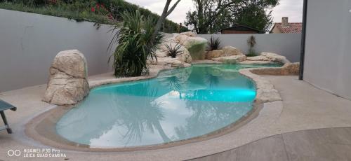 une petite piscine avec des rochers dans une cour arrière dans l'établissement Villa de vacances, à Le Teil