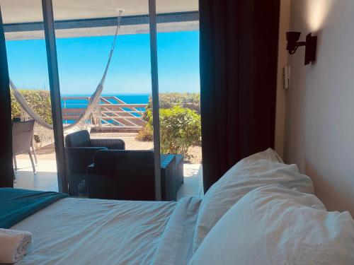 a bedroom with a bed and a view of the ocean at Sunny Home Costa Plana-Monaco -Cap D'Ail in Cap d'Ail