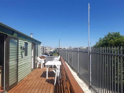 a wooden deck with a table and chairs on it at Kerrys Place, 75 Sealands Caravan Site, Ingoldmells 6 Berth in Ingoldmells