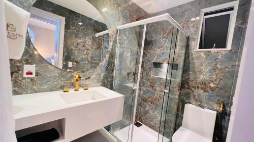 a bathroom with a sink and a shower at D'Blue Búzios Hotel Boutique in Búzios