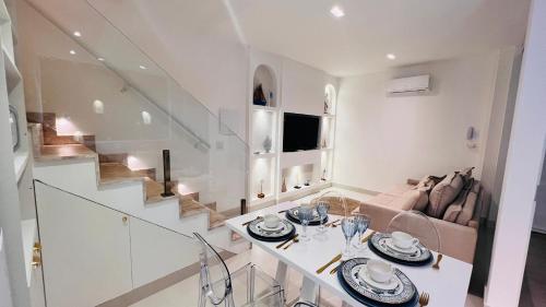 a living room with a table and a couch at D'Blue Búzios Hotel Boutique in Búzios