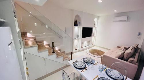 a living room with a staircase and a couch at D'Blue Búzios Hotel Boutique in Búzios