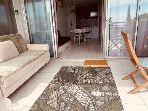 a living room with a couch and a table at Sunny Home Costa Plana-Monaco -Cap D'Ail in Cap d'Ail