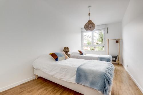 Postel nebo postele na pokoji v ubytování Porte de Paris - Stade de France