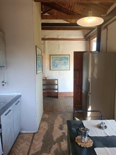 a kitchen with a refrigerator and a table in a room at Casa Nati in Casale di Pari