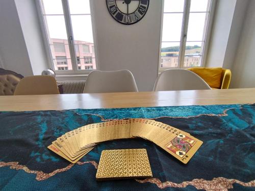 a table with a ribbon on top of a table with a clock at The 5 Continents II by Stay Swiss in Porrentruy
