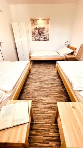 a room with three beds and a book at Apartmány Hvězdecká in Broumov
