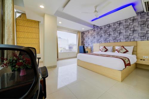 a hotel room with a bed and a window at Hotel Grand Suites By D'Capitol Near IGI Airport in New Delhi