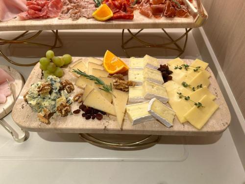 a tray of cheese and fruit on a table at ARCELON HOTEL - From 2023 in Barcelona