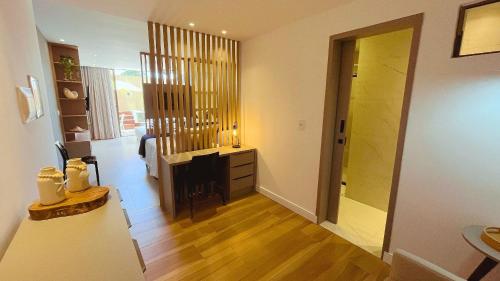 a hallway with a living room with a fireplace at Flat FM20 Cabo Branco Piscina Privativa - By Almare in João Pessoa