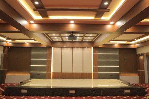 a large room with a stage in the middle at KANS ONE - Hotel & Banquets in Chennai