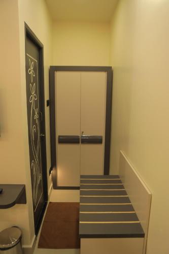 a hallway with a glass door and a stair case at KANS ONE - Hotel & Banquets in Chennai