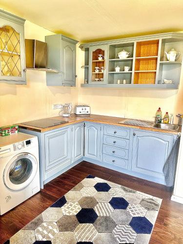 a kitchen with a washing machine and a washer at Kildare Luxury Suites in Kildare