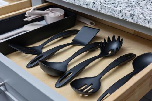 a drawer with black utensils in a kitchen at Pier View - Spacious Home Sleeps 8 - Pet Friendly in Myrtle Beach