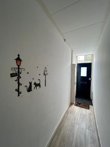 a hallway with a wall with cats and street lights at Stay and Sleep in Leeuwarden