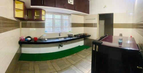 a kitchen with a counter and a sink in a room at Wild Wagon Service Villa in Meppādi