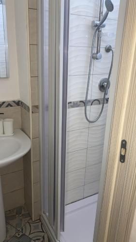 a bathroom with a shower and a sink at Home Giove in Giardini Naxos