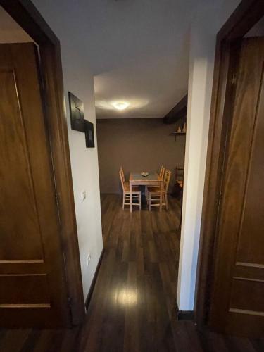 a hallway with a table and chairs in a room at El Rencuentro in Villarejo del Valle