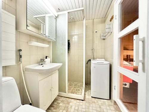 a bathroom with a toilet and a sink and a shower at EP City Suite - Sauna, Balcony & Free parking in Tampere