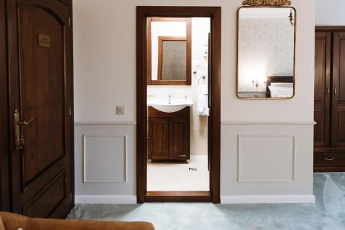 a bathroom with a sink and a mirror at Casa Salzburg in Sibiu