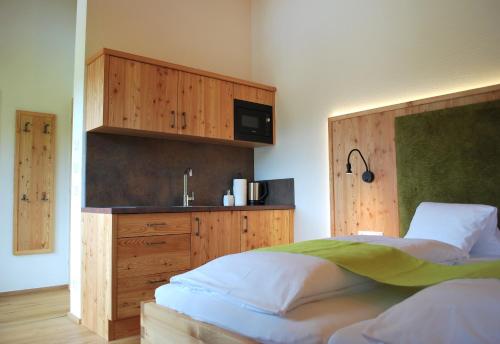 a bedroom with a bed and a cabinet with a microwave at Hinkerhof in Schladming