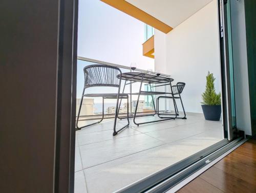 a balcony with a table and chairs on it at Seaview wonder apartment by Anna in Funchal