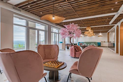 a living room with a chessboard on a table and chairs at Casa Deniso - The Home of Chill in Byala