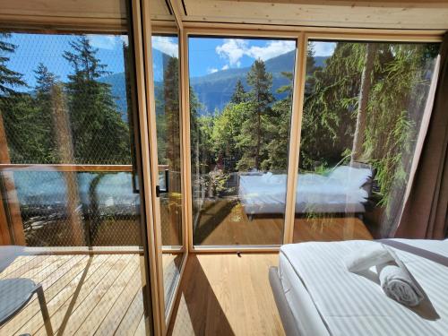 a room with a view of a mountain through windows at Zoo des Marécottes Boutique Hôtel in Les Marécottes