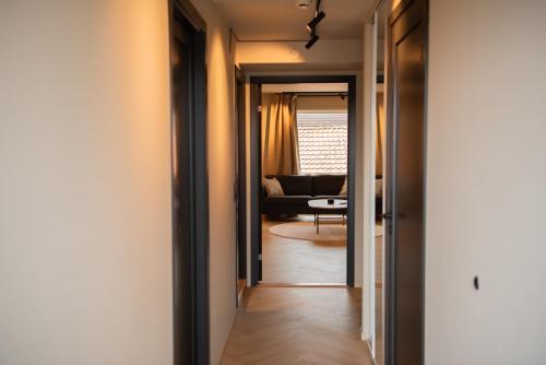 a hallway leading to a living room with a couch at Penthouse, heart of city center, high standard in Stavanger