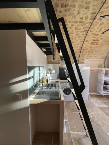 une cuisine avec une cuisinière et un comptoir dans l'établissement Chez mamie Claudine, à Mornas