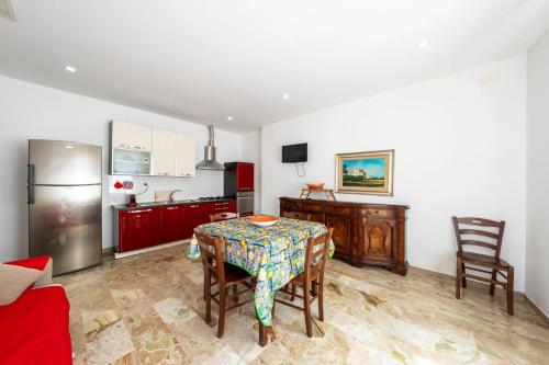 a kitchen and dining room with a table and chairs at Residence Anna - Red Apartment in Roseto degli Abruzzi