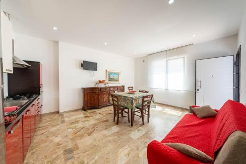 a living room with a red couch and a table at Residence Anna - Red Apartment in Roseto degli Abruzzi