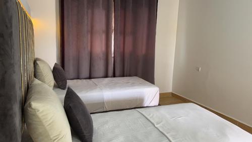 a hotel room with two beds and a window at camping atlantique tan tan in Tan-Tan Plage