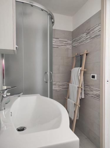 a bathroom with a white sink and a shower at Il Leccio in Ischia Town