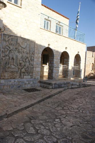 a building with a relief on the side of it at Thelea Mani in Kafióna
