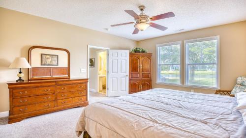 a bedroom with a bed and a dresser and a mirror at 511 Heron Bay in Briarwood
