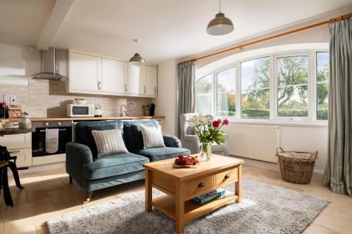 a living room with a couch and a table at May Cottage in Bridlington