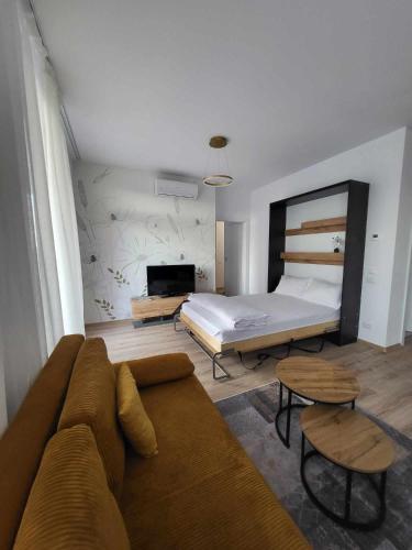 a living room with a couch and a bed at Sika Splendor Apartment - cazare premium Arad - self check-in in Arad