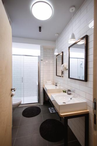 a bathroom with two sinks and a toilet and a mirror at MAKS 3 Osijek Center, self check in, free parking in Osijek