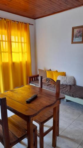 a living room with a wooden table and a couch at Hospedaje Navarro Dpto N3 matrimonial in Navarro