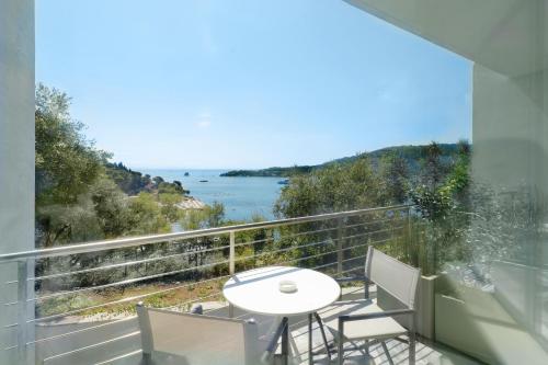 a balcony with a table and chairs and a view of the water at Cristallo Park Hotel in Portovenere