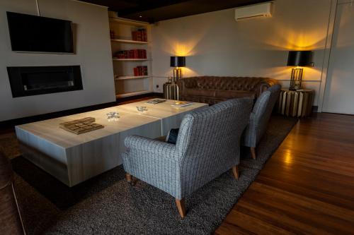 a living room with a table and two chairs at Hotel Hita "Nature Experience" for all in Navacerrada