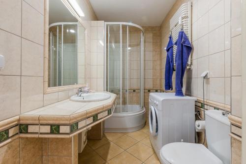 a bathroom with a toilet and a sink at Ustka Apartament Na Wydmie 4 in Ustka