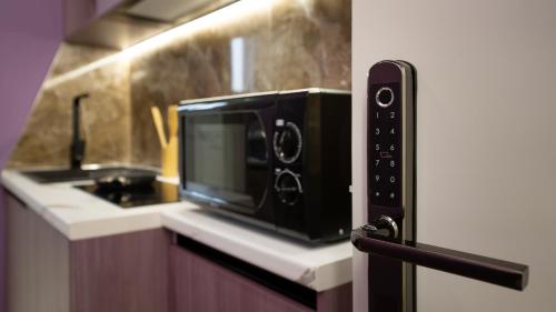 a microwave sitting on a counter in a kitchen at Circle Tirana City Center in Tirana