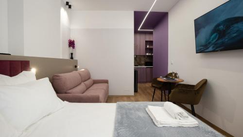 a bedroom with a bed and a living room at Circle Tirana City Center in Tirana