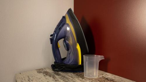 a iron sitting on a table next to a glass at Circle Tirana City Center in Tirana