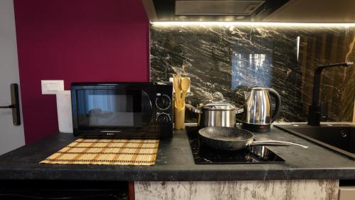 a microwave sitting on top of a kitchen counter at Circle Tirana City Center in Tirana