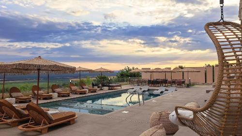 a swimming pool with lounge chairs and tables at Casa Deniso - The Home of Chill in Byala